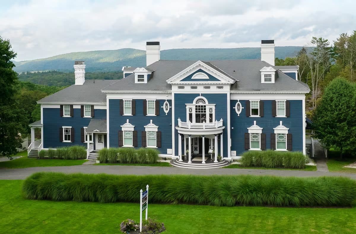 The Kemble — a slate-blue Gilded Age mansion with a white columned portico